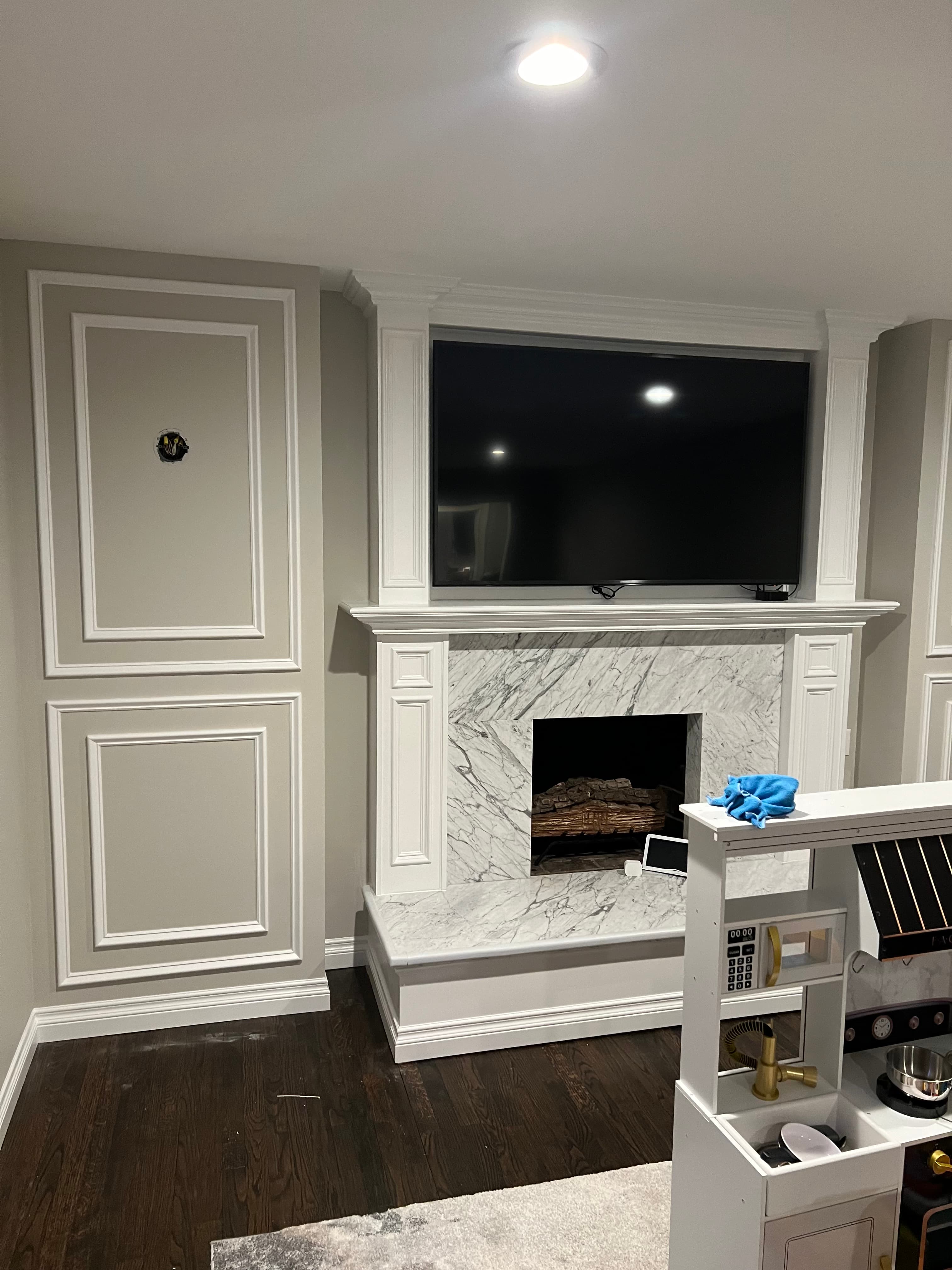 Contemporary kitchen with white cabinets and marble backsplash
