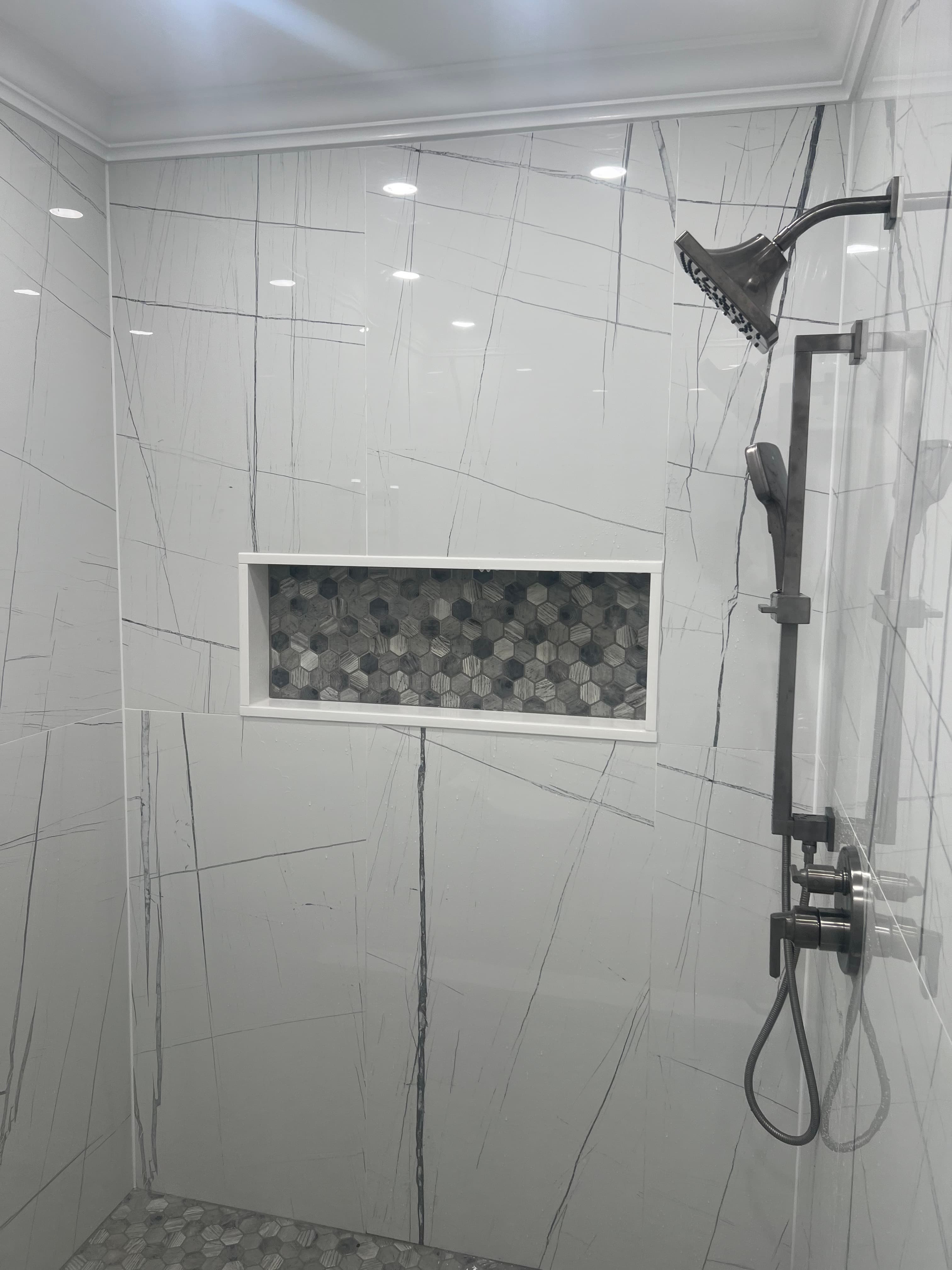 Luxury bathroom with custom shower and hexagonal tile
